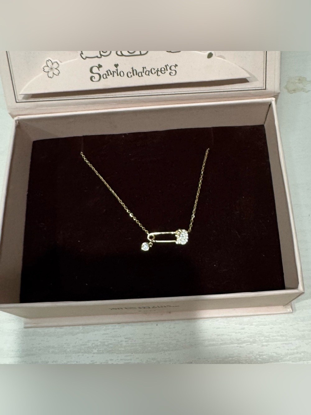 Sanrio Hello Kitty Gold-Tone Safety Pin Necklace with Crystal Charm